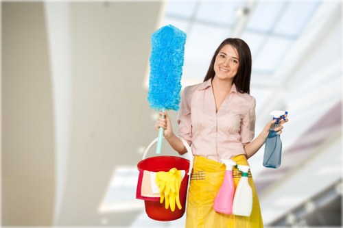 Professional carpet cleaner using equipment with careful workplace precautions